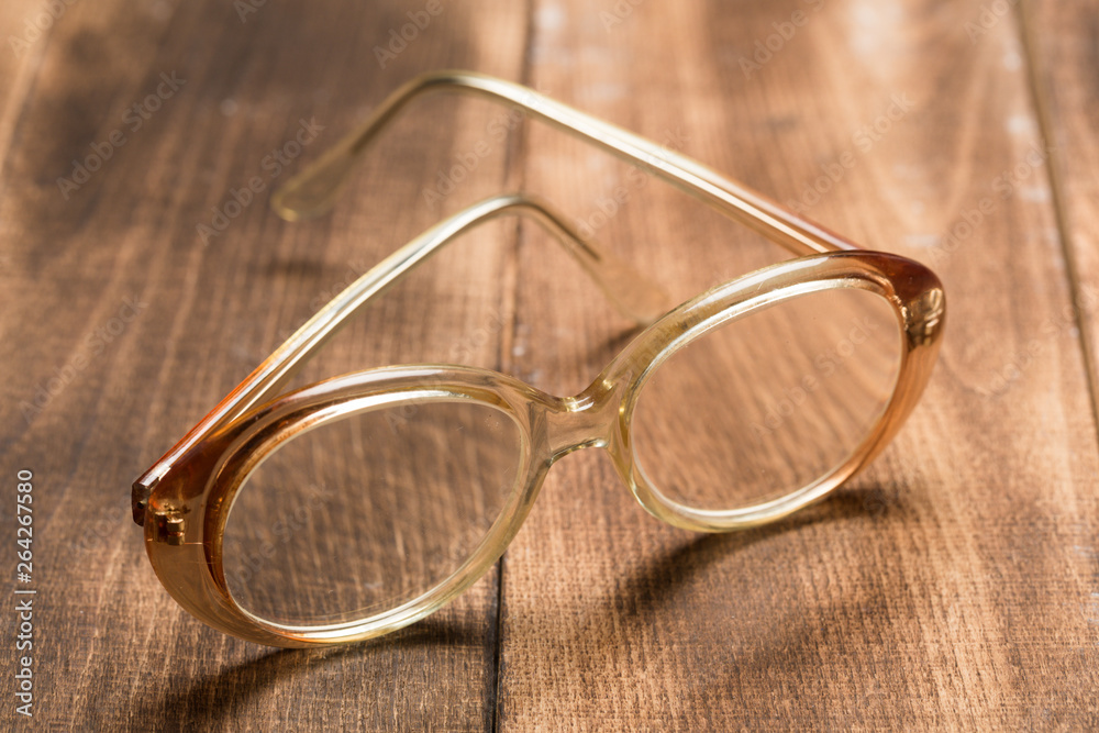 Poster old glasses on wooden surface