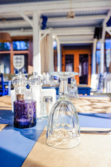 Wonderful restaurant in a loft style. shelves with dishes and equipment. tables ready for clients.Traditional Mediterranean restaurant interior design. Wooden Furniture in the restaurant. Table