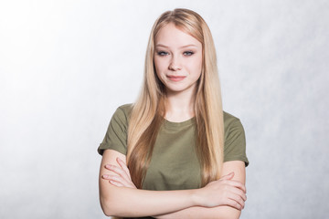 Fototapeta premium Portrait of a young beautiful smiling woman on a gray background.