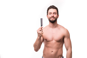 Fototapeta premium Close up portrait of satisfied glad excited cheerful virile masculine muscular bearded with toothy smile handsome guy demonstrating comb isolated on gray background
