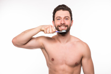 Fototapeta premium Handsome young man brushing his teeth isolated on white background