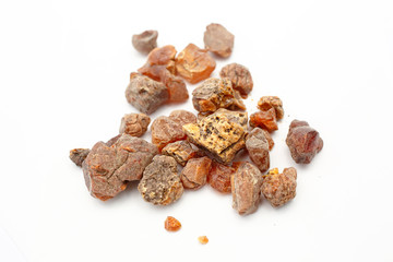 Amber. Many pieces of different types of fossil amber resin on a white background. Ancient petrified resin. Natural mineral. Material for jewelers. Sun Stone Crystal. Semiprecious stone.