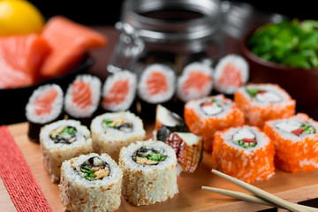 Asian cuisine. Sushi on a wooden board with chopsticks.