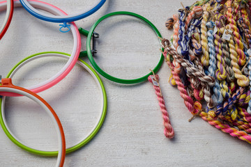 Multicolored embroidery hoops for creative art and threads of floss braided threads for embroidery.