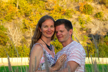 Romantic moment in park, couple portrait in high grass outdoor.