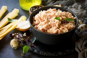Minced meat, pasta and ingredients for cooking minced meat in a bowl on a slate.