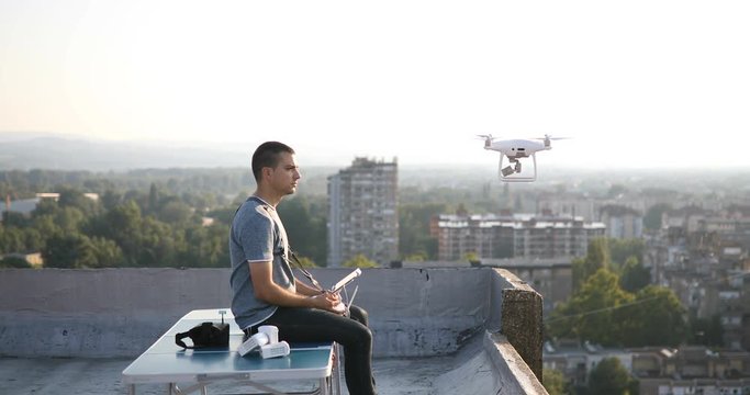 Man with drone flying at the city. Aerial cityscape drone view