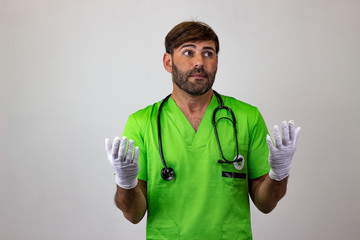 Portrait of male veterinary doctor in green uniform with brown hair embarrased, looking at the...