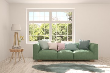 Stylish room in white color with sofa and summer landscape in window. Scandinavian interior design. 3D illustration
