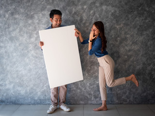 Asian Man and woman with white banner copy space