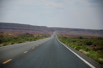 Empty road leading to a curve in desert USA