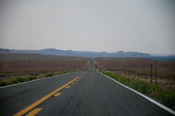 Very long straight highway in desert USA