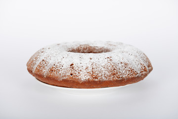 The hand-made cake with white sugar powder on it