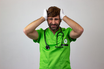 Portrait of male veterinary doctor in green uniform with brown hair stressed, looking at the camera. Isolated on white background.