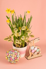 Spring composition with narcissus flowers, goat willow branches and Easter decor
