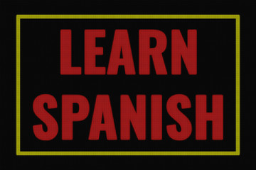 Fototapeta premium Learn Spanish word on dark screen