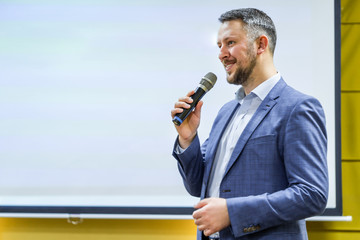 Businessman speaking at a podium in a conference or seminar