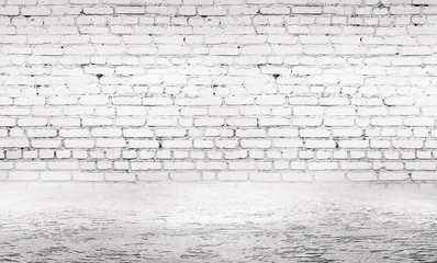 Background of empty gray room with brick wall and concrete floor.