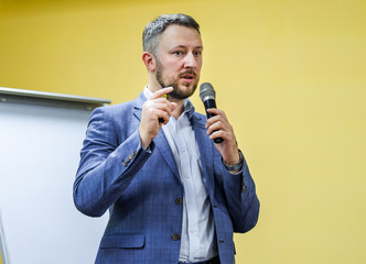 Businessman speaking at a podium in a conference or seminar