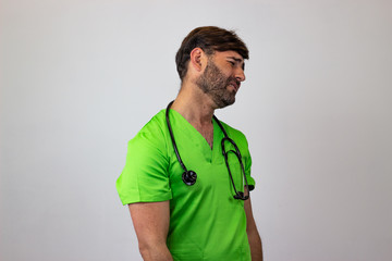 Portrait of male veterinary doctor in green uniform with brown hair crying, facing forwards and...