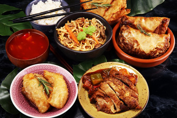 Assorted Chinese food set. Chinese noodles, fried rice, peking duck, dim sum, spring rolls. Famous Chinese cuisine dishes on table. Chinese restaurant