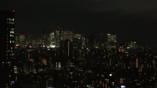 TOKYO,  JAPAN - CIRCA APRIL 2019 : Aerial view of office buildings around Shinjuku area at night.  View from Bunkyo ward.