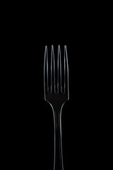 Elegant fork on black background