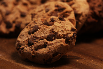 Fototapeta premium Chocolate cookies on wooden table. Chocolate chip cookies