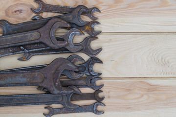 Old spanners on a wooden table.
