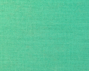 Textured background of green natural textile  