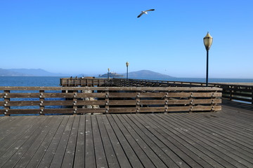 Pier 39 in San Francisco Bay Area with Alcatraz Island in the background