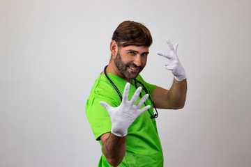 Portrait of male veterinary doctor in green uniform with brown hair holding up eight fingers, their back facing the camera and looking at the camera. Isolated on white background.