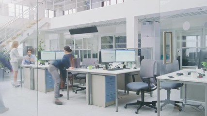 Time-Lapse In the Modern Open Space Office Businessmen and Businesswomen Working, Walking Through Hallway, Using Tablet Computer, Having Discussions, Finding Solutions and Working on Desktop Computers - Powered by Adobe