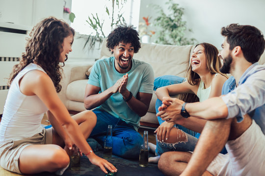 Group of young friends playing game of truth. Home party.