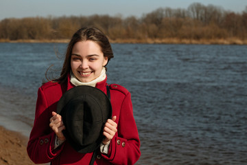 Young girl enjoys spring sun near a river