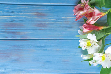 Frame for greeting card with flowers. Banner with natural alstroemeria flowers on a wooden background. Frame for text with flowers of alstroemeria. Flat lay, top view.
