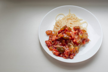 Macaroni with vegetables on a white plate