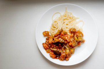 Macaroni with vegetables on a white plate