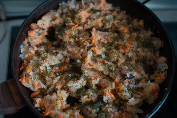Potatoes with vegetables on a frying pan