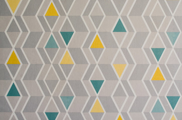 Triangles pattern on the texture of space, abstract background. Simple geometric illustration. Yellow, gray and green triangles.