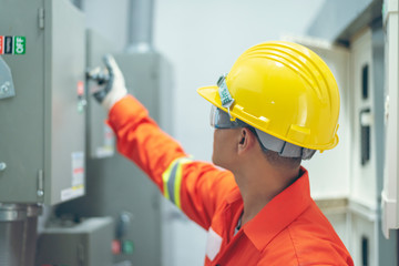 close up men working with the control cabinet