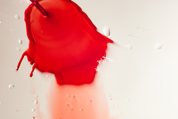 Fototapeta na wymiar Flow of red liquid with drops