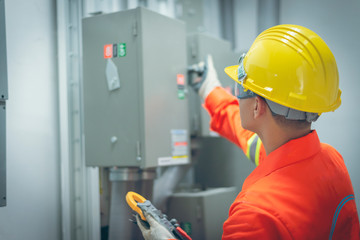 close up men working with the control cabinet