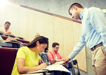 Obraz premium education, high school, teaching, university and people concept - group of international students and teacher at lecture hall