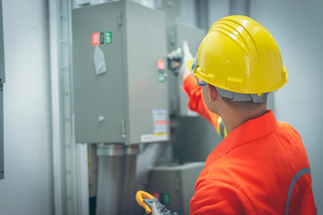 close up men working with the control cabinet