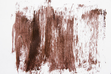 Texture of brown mascara isolated on white background. A smear of brown mascara on a white background. Brown mascara smeared on white background