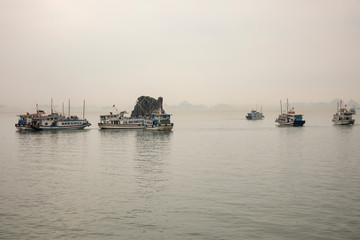 Tour boats around kissing rock in Ha Long Bay Vietnam