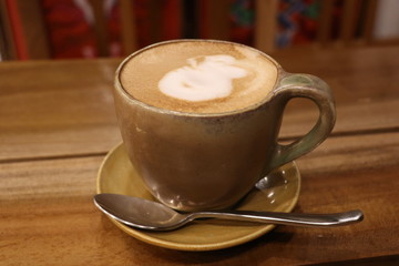 cup of coffee on wooden table