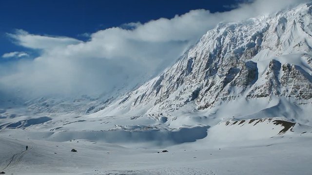 Panoramic shot of Tilicho lake area and high snowy and icy mountains around. Hiking and trekking in Nepal, spring trek around Annapurna mount.