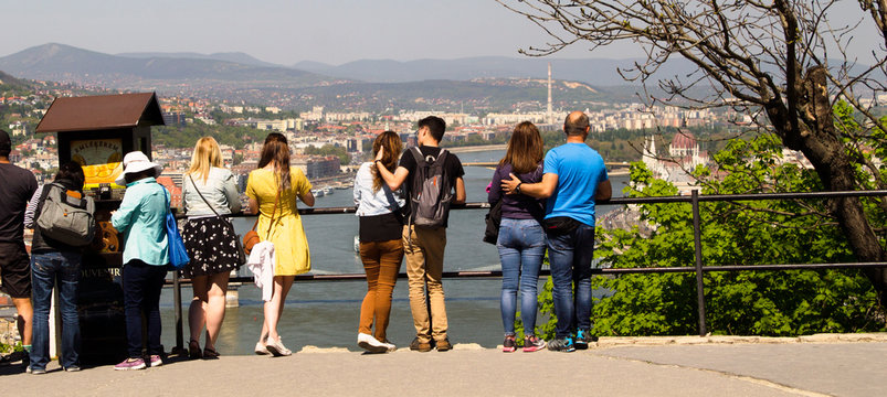 tourists are looking at Budapest - a view of the city of Pest from the hills, Citadella Fortress in Budim